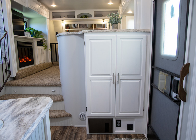 Entry cabinet with bright white trim and gray walls.