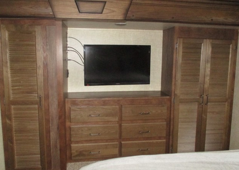 Original bedroom cabinetry which is heavy and dark in color.